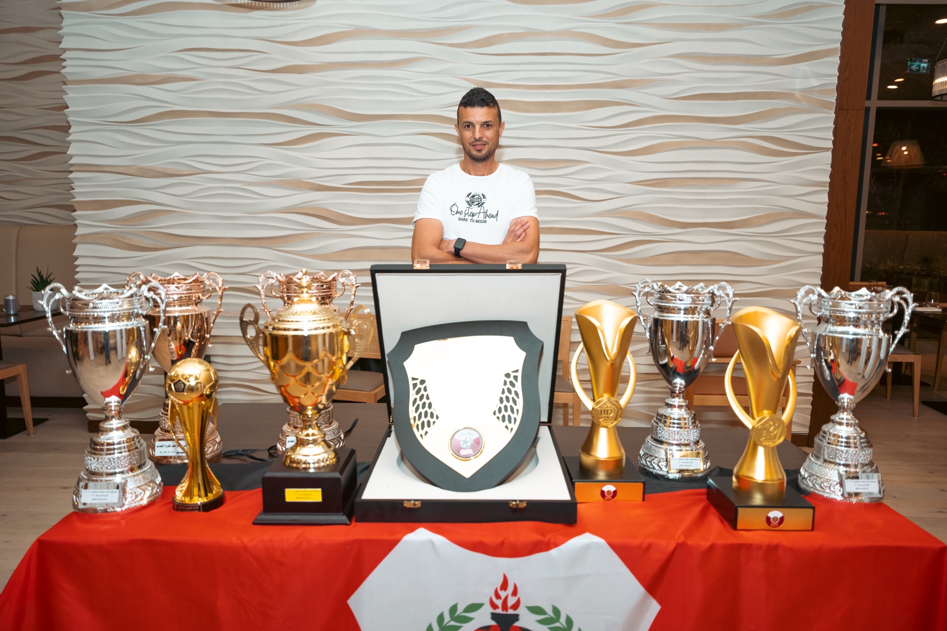 Coach with championship trophies